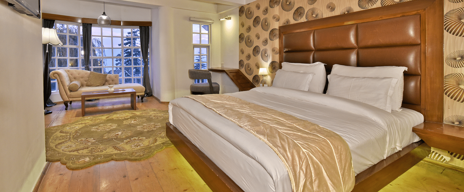 Spacious suite featuring a bedroom with a living area at DLS Hillcrest Resort, Shimla.